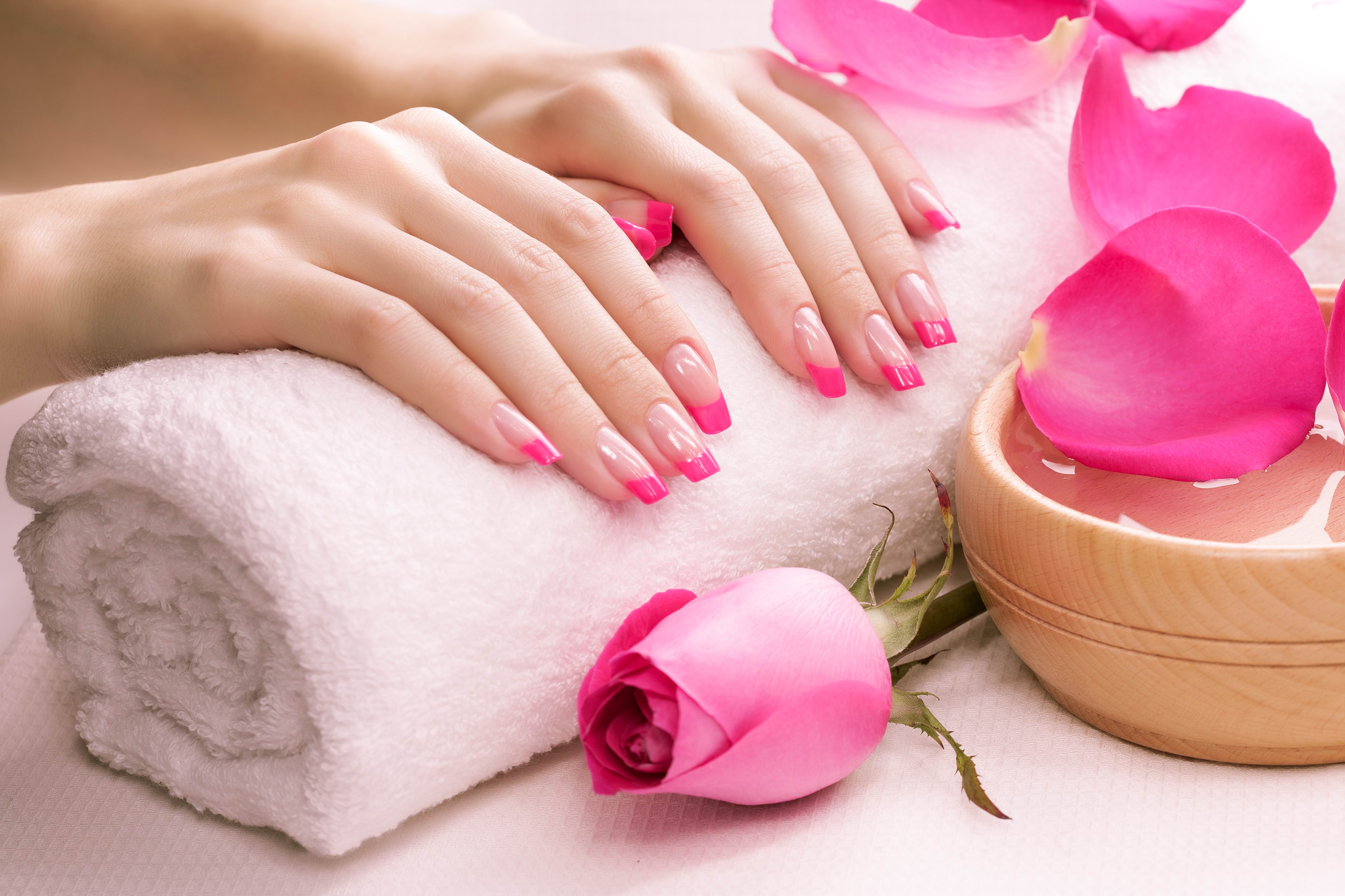 pink manicure with fragrant rose petals and towel