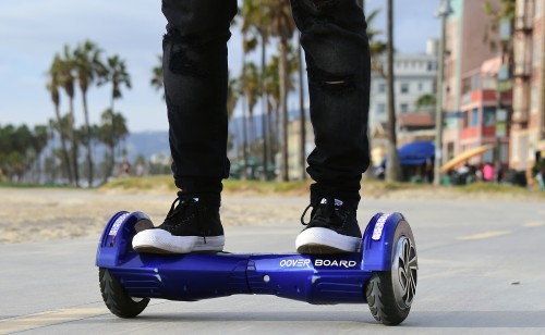 Michael Tran uses his hoverboard on the Venice Beach Boardwalk on December 10, 2015. The hot item on many holiday lists will help you zip around town, the shopping mall and from one end of the workplace to another.These so-called "hoverboards" or self-balancing electric scooters, are surging in popularity in the first season where they have been available at relatively affordable prices -- as low as $300 for some models. AFP PHOTO/ FREDERIC J. BROWN / AFP / FREDERIC J. BROWN (Photo credit should read FREDERIC J. BROWN/AFP/Getty Images)